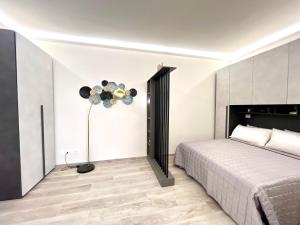 a bedroom with a bed and a lamp at Garibaldi Living - Centro Storico Parma in Parma