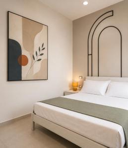 a bedroom with a bed and a painting on the wall at The Arco Rooms in Pomigliano dʼArco