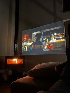 a tv screen in a living room with a person on it at Niva Rest in Pilica