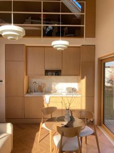 a kitchen with a table and chairs in a room at Niva Rest in Pilica