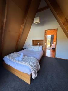 a bedroom with two beds in a attic at Awhina's Lodge in Ohakune