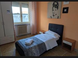 a bedroom with a bed and a window at Pearl Pisa guest house in Pisa +10 photos