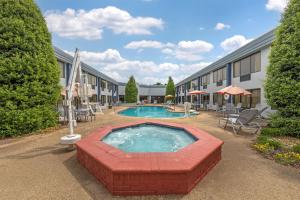 a pool in a courtyard with a building at Best Western Plus Madison-Huntsville Hotel in Madison