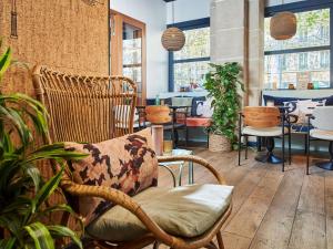 a room with chairs and tables and plants at Ibis Styles Hotel Paris Gare de Lyon Bastille in Paris