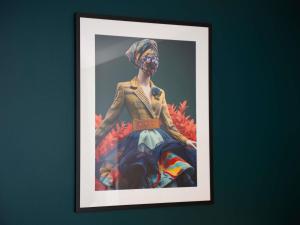 a picture of a woman in a dress on a wall at Maek Hotel Antwerp Central - Accor Handwritten Collection in Antwerp