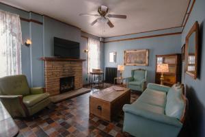 a living room with a couch chairs and a fireplace at Old Clark Inn in Marlinton