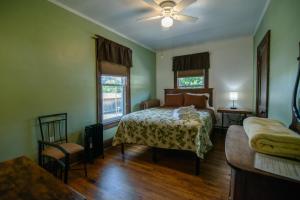 a bedroom with a bed and a couch at Old Clark Inn in Marlinton