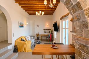 a living room with a couch and a table at Villa Markiani in Aegiali