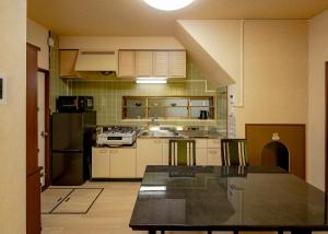 a kitchen with a counter top and a refrigerator at 笑福邸 in Shiogama