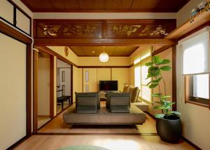a living room with a couch and a television at 笑福邸 in Shiogama