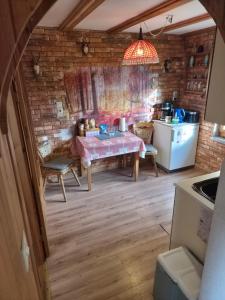 a kitchen with a table and a kitchen with a refrigerator at Idylissches Ferienhäusle im Thüringer Wald in Suhl +18 photos