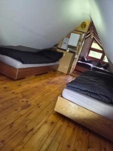 a bedroom with two beds in a tent at Idylissches Ferienhäusle im Thüringer Wald in Suhl