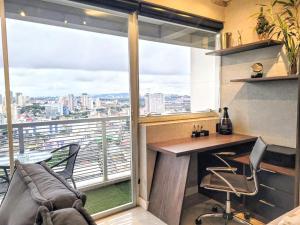 a home office with a desk and a large window at The Cittyplex Home Osasco Estilo & Conforto in Osasco +52 photos