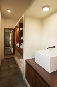 a bathroom with a white sink and a mirror at Angelique's Boutique Spa & Suites in La Unión