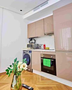 a kitchen with a vase with flowers in it at Prestige studio in Maarif