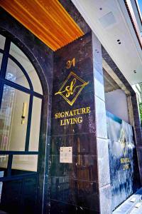 a front door of a building with a sign for a signature living at Prestige studio in Maarif