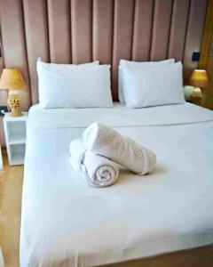 a pile of towels sitting on a bed at Prestige studio in Maarif