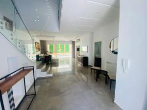 a room with a staircase and a living room at Villa haut-standing avec piscine à Hammamet in Yasmine