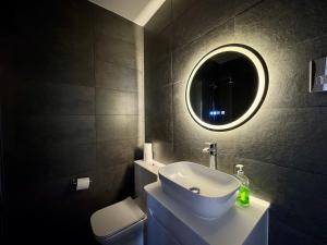 a bathroom with a white sink and a mirror at Palm Bay Residency in Cliftonville +55 photos