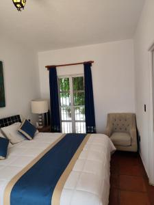 a bedroom with a large bed and a window at Casa de las Conchas Cuernavaca in Cuernavaca