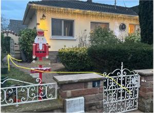 a house with a christmas ornament in front of a gate at Jolie chambre ambiance zen in Illkirch-Graffenstaden