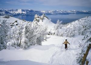 a person is skiing down a snow covered slope at Tahoe Keys #214 in South Lake Tahoe
