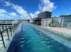 a swimming pool on the roof of a building at Flat FM20 Apt 401 in João Pessoa