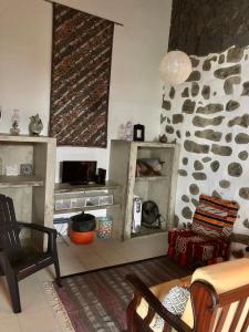a living room with a stone wall at Xaminé in Água Retorta
