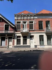 an old brick building on a city street at Grachtenpracht Boutique in Breda