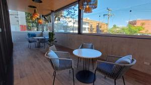 a restaurant with tables and chairs and a window at Cozy Apartment 4 degrees north in Las Victorias