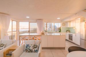 a kitchen and living room with a view of the ocean at Seacrest 9 in Gold Coast +17 photos