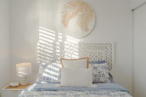 a bedroom with a bed with blue and white pillows at Seacrest 9 in Gold Coast