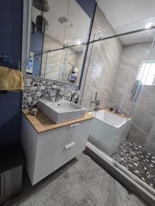 a bathroom with a sink and a shower and a tub at Room with Shared Bathroom - Stampede & Mountains in Calgary +4 photos