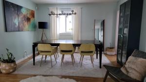 a dining room table and chairs in a living room at Room with Shared Bathroom - Stampede & Mountains in Calgary