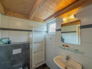 a bathroom with a sink and a mirror at Villa Alpenrose in Kötschach +48 photos