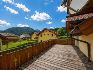 a wooden balcony with a view of a village at Villa Alpenrose in Kötschach