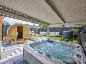 a jacuzzi tub on a patio in a backyard at t Margrietje in Riemst