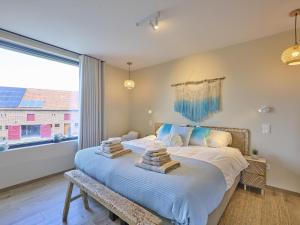 a bedroom with a bed with towels on it at t Margrietje in Riemst