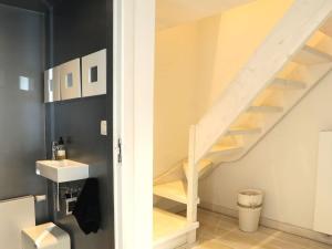 a bathroom with a sink and a staircase at Agathe in Laforêt +52 photos