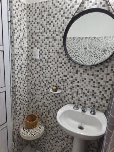 a bathroom with a sink and a mirror at Noche Hermosa in Chilecito
