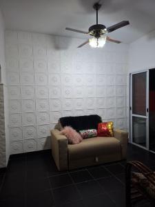 a living room with a couch and a ceiling fan at Noche Hermosa in Chilecito
