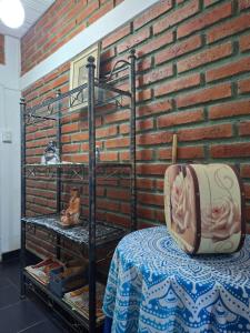 a room with a bed and a brick wall at Noche Hermosa in Chilecito