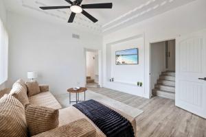 a living room with a couch and a ceiling fan at 2Homes Villa Renovated Views in La Mesa