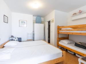 a bedroom with two bunk beds and a refrigerator at 2000 - 0302 + park. 3 in Middelkerke +2 photos