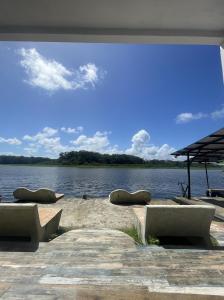 a dock with a view of a body of water at Hotel Pura Natura Riverside Tortuguero in Tortuguero