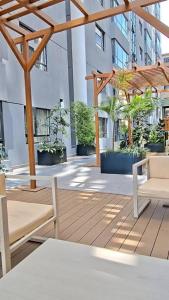 a patio with chairs and a pergola in a building at Neptune Luxe in Nairobi