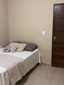 a bedroom with a bed with a black and white blanket at Departamento #10 in San Carlos