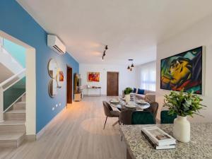 a living room with a table and a dining room at Playa Palmera Beach Resort in Punta Cana