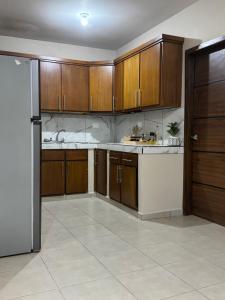 a kitchen with wooden cabinets and a refrigerator at Departamento #10 in San Carlos