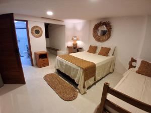 a bedroom with a bed and a mirror on the wall at Casa Irmã Lua in Porto Seguro